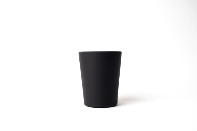 Reusable black cup (330ml) made from bamboo .