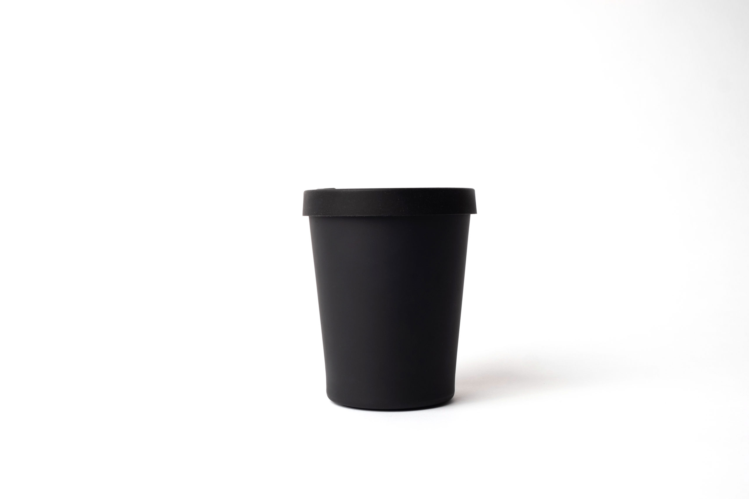 Reusable black cup (330ml) made from bamboo with black silicon lid .
