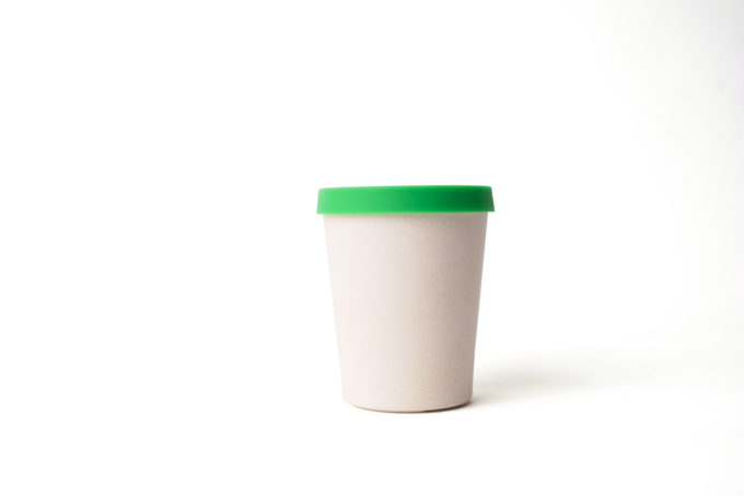 Reusable beige cup (330ml) made from bamboo with green silicon lid.