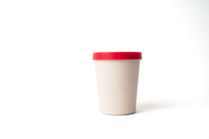 Reusable beige cup (330ml) made from bamboo with red silicon lid.