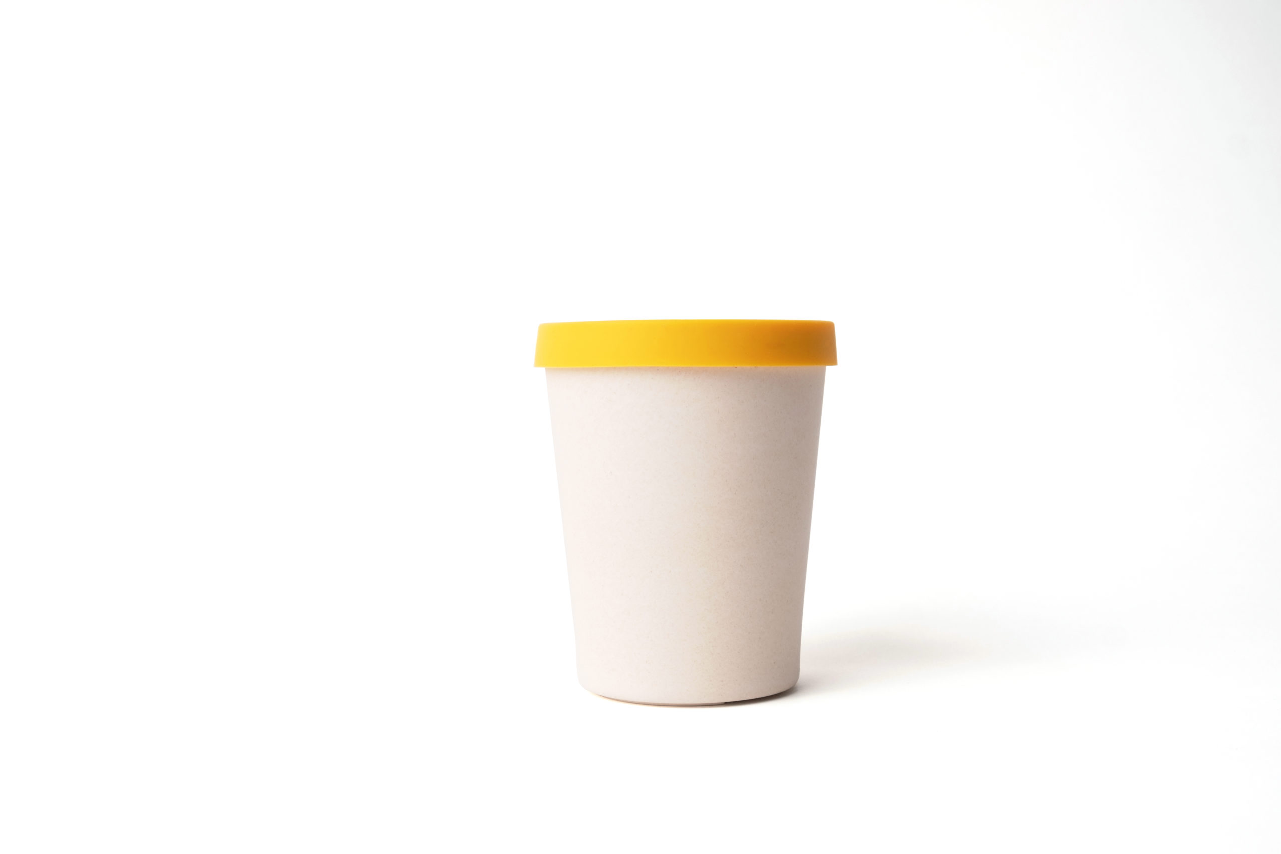 Reusable beige cup (330ml) made from bamboo with yellow silicon lid.