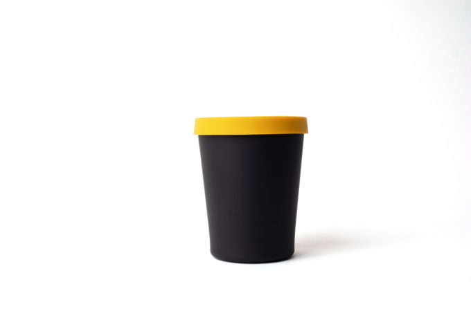 Reusable black cup (330ml) made from bamboo with yellow silicon lid .