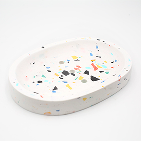 Soapdish Cannes Av de Grasse, white and terrazzo color, oval shape with three draining holes, handmade in Berlin by Kula.