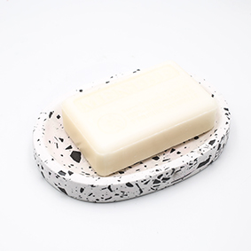 Soap dish Cannes rue du Rocher, black and white terrazzo color, oval shape with three draining holes, handmade in Berlin by Kula.