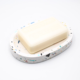 Soapdish Cannes Av de Grasse, white and terrazzo color, oval shape with three draining holes, handmade in Berlin by Kula.