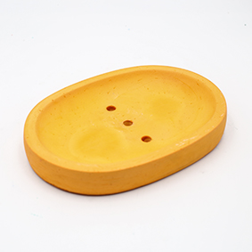 Orange Soapdish Cannes Av des Coteaux, oval shape with three draining holes, handmade in Berlin by Kula.
